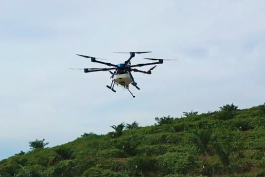 Precision spraying drone operating over plantation with digital compliance data overlay